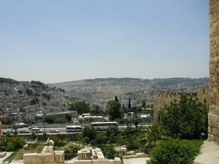 View from the steps of the Temple. For those with a little Sunday School, the 'Temple' is where Christ ran out the moneylenders. If he had turned around while he was running into the Temple, this is what he would have seen. The town across the road is Palestinian. The Al Aqsa mosque is directly above and behind me.