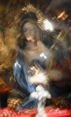 Mary. I'm not sure which one. There are (admittedly hard to see) jewels on the red velvet before her chest, but only a few, as the original pile of jewelry left by rich pilgrims and foreign governments was stolen several years ago. Rumor has that it was an inside job.