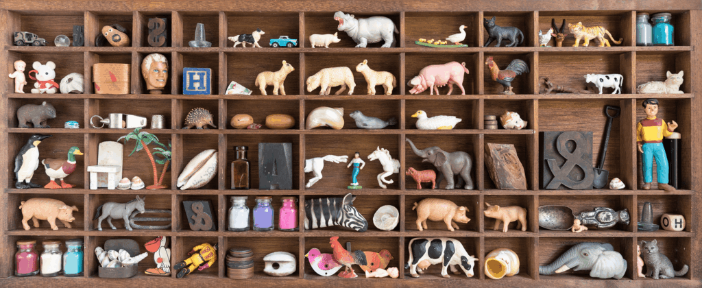 Image of small wooden shelves with tiny animal figures on them.