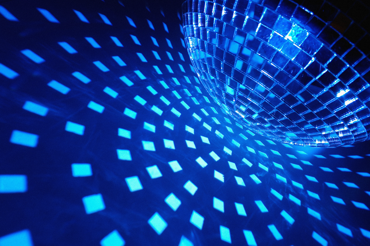 image of a blueish disco ball illuminating a light blue pattern on a darker blue surface.