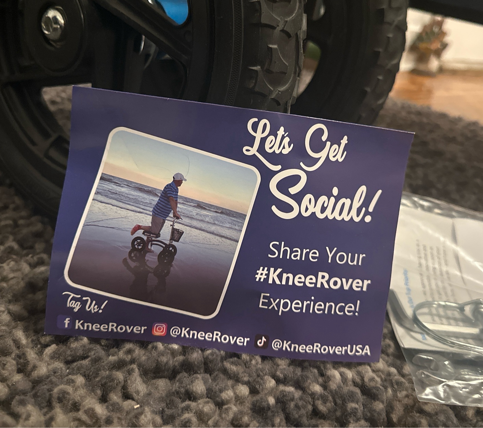 A postcard that says “Let’s get social! Share your KneeRover Experience!” With a picture of some dude knee rovin on the beach. Fml.