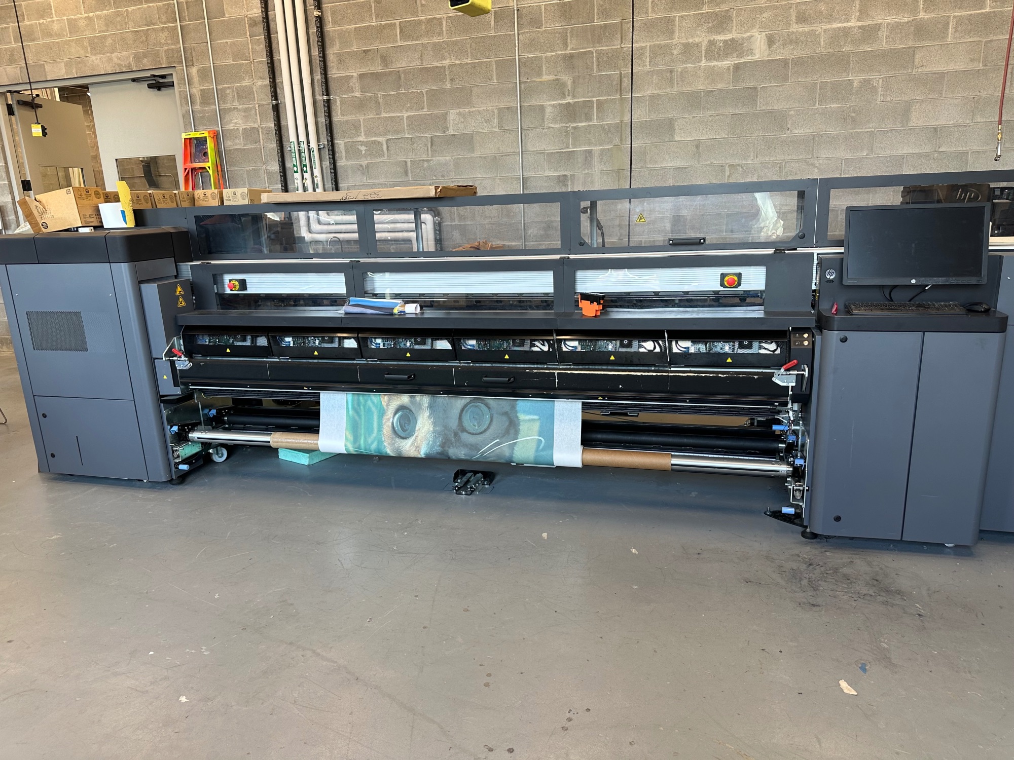 An enormous printer like 20 feet wide. There’s a bit of cat face with huge eyes printed underneath, like five feet wide.