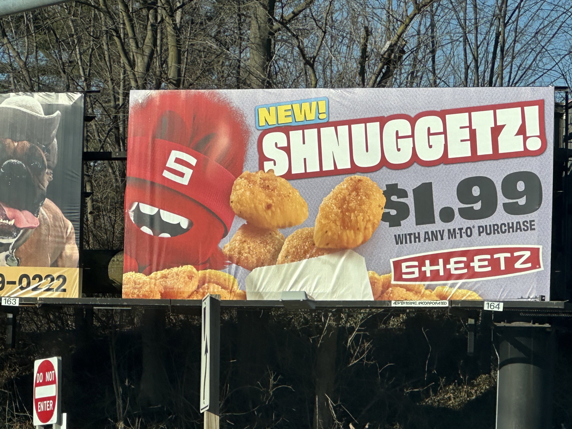 Sign for SCHNUGGETZ from Sheetz for $1.99. Hideous meat fried and a weird mascot in red with a band across its mouth that looks like a sort of living hemorrhoid.