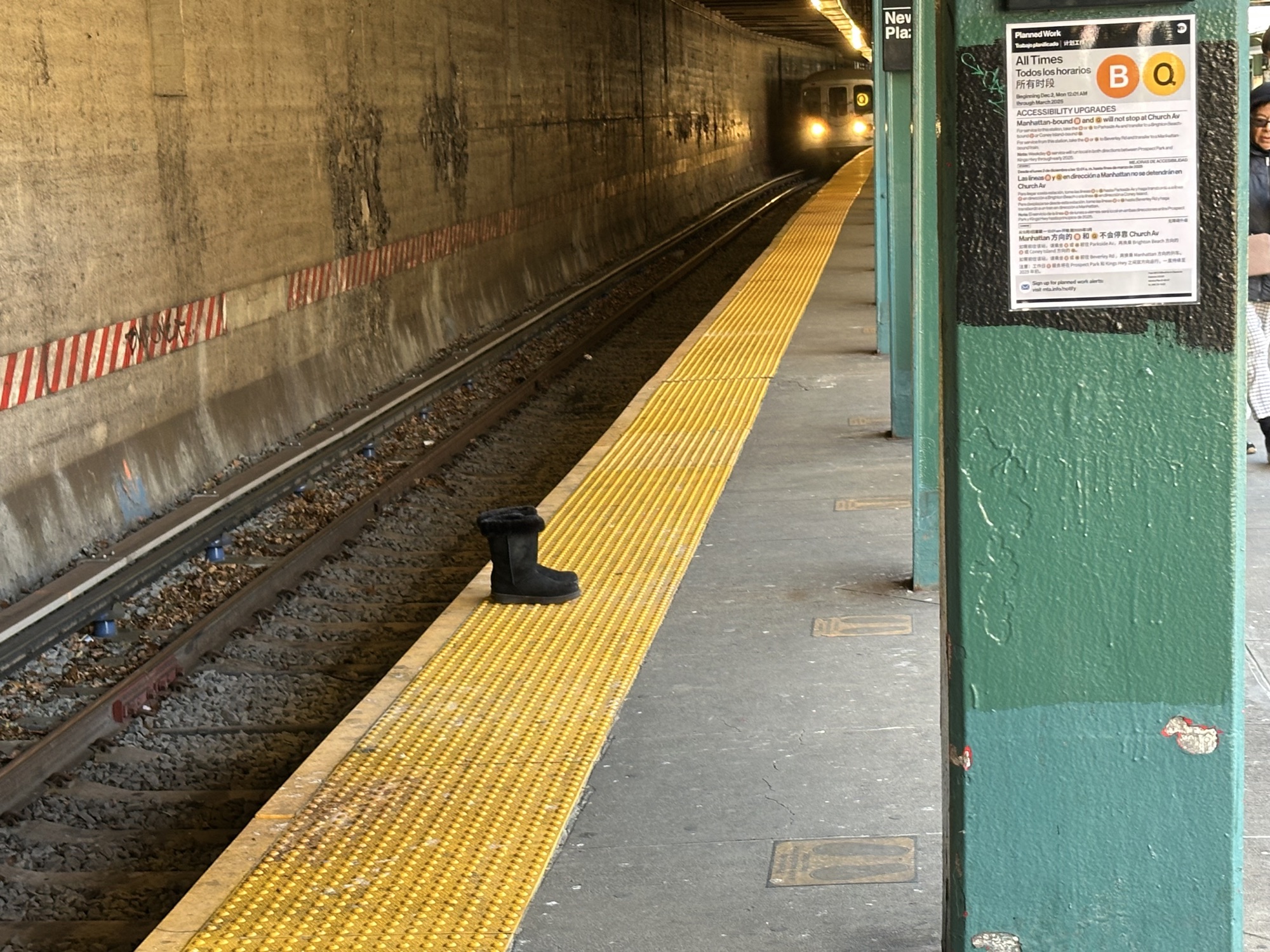 A lone pair of furry boots on the subway platform, as the train comes in. They’re right where the train will stop. It’s strange. 
