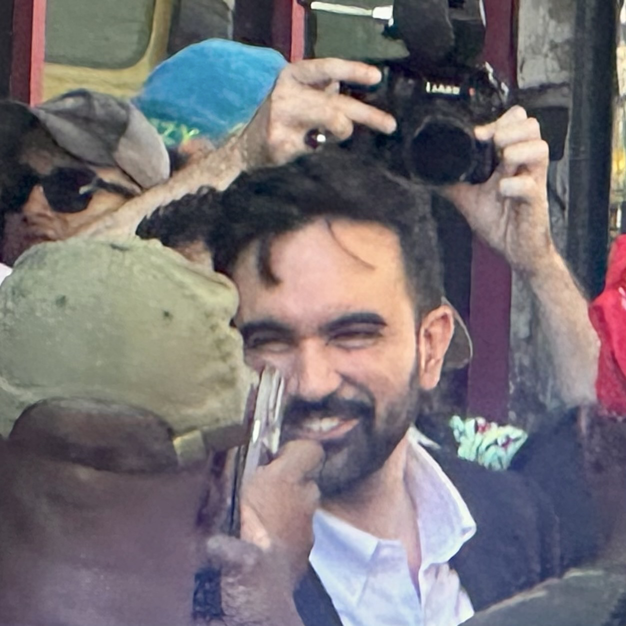 Zohran Momdani surrounded by well wishers and cameras in Brooklyn. 