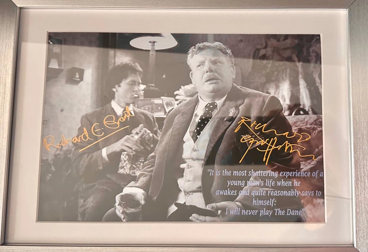 A black and white framed photo of Richard Grant and Richard Griffiths, signed in gold pen. A quote from Withal & I is printed atop Griffiths: "It's the most devastating moment in a young man's life, when he quite reasonably says to himself, 'I shall never play The Dane!'"