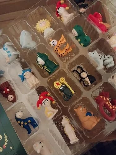 A plastic case with extremely ridiculous plastic cheap cats in a few colors, like the stuff you get at the dentist's office.
